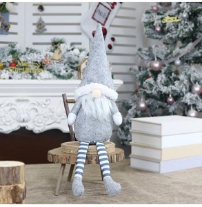 Close-up of grey and white striped Christmas gnome with long legs on wood stand