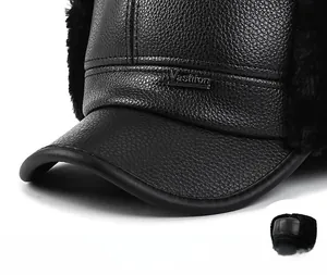 Detail of winter trapper hat featuring premium leather texture and durable curved brim