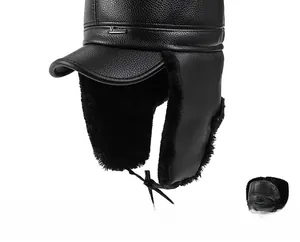 Detail of winter trapper hat with thick black faux fur lining and premium leather texture