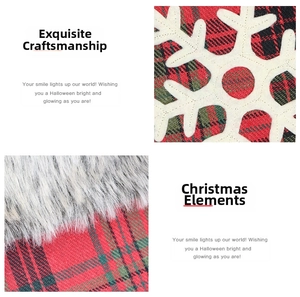 Detail of red plaid Christmas stocking fabric with white snowflake applique and plush trim
