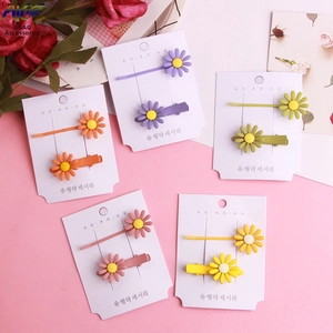Close-up of colorful daisy flower hair clip set with matte finish on display card