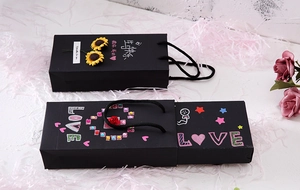 Close-up of a creative gift bag and love-themed surprise box for romantic gifts