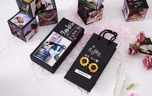 Detail view of DIY jumping surprise gift box set with black photo cubes and sunflowers