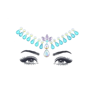 Macro detail of blue teardrop and purple leaf resin crystals on decorative face jewels