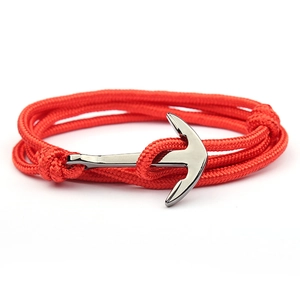 Handmade red braided nylon rope anchor bracelet with gun black metallic clasp on white background