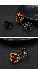 Detailed macro view of Gothic punk coffin rings with skulls and red gemstone settings