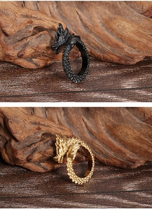Macro detail of dragon head ring with intricate scales in antique gold and black finishes
