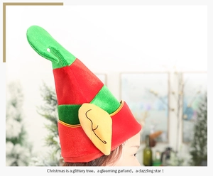 Detail of red and green velvet Christmas elf hat with yellow ears on a model