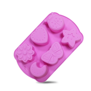 Macro detail of a 6-cavity pink silicone insect and flower mold for jelly or baking