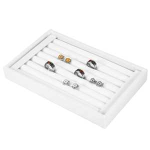 White velvet jewelry display tray with multiple slots for rings and pearl earrings