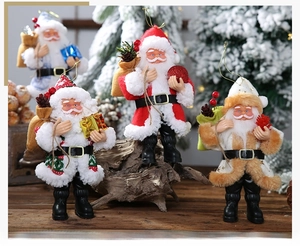 Detailed close-up of four Santa Claus ornaments with berries and gift boxes in a snowy scene