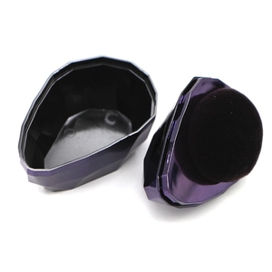 Detailed view of a purple diamond-cut powder case with a black flocking sponge puff