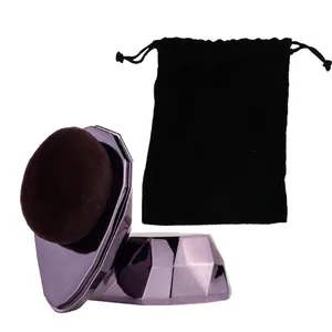 No-trace foundation brush with diamond-cut handle and black velvet pouch on white background