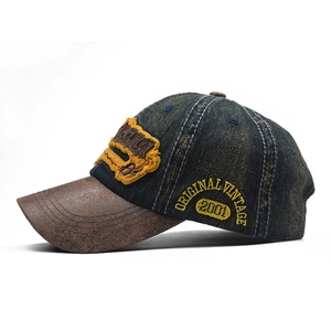 Vintage denim baseball cap with brown distressed brim and yellow letter embroidery