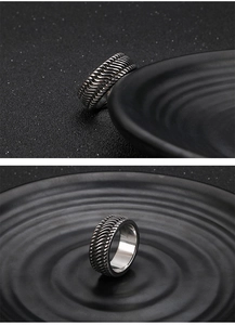 Detailed view of vintage steel motorcycle ring with textured tire pattern and silver finish