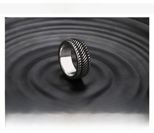 Detail showing the intricate tire tread texture on the black stainless steel band