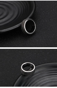 Detailed close-up of retro silver stainless steel ring with textured tire tread pattern