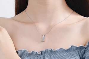 Close-up of a minimalist rectangle pendant necklace with pavé-set shimmering zircon stones