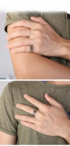 Detail of men's two-tone silver and gold spiral textured ring worn on model's hand