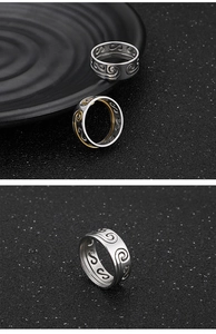 Macro detail of gold and silver filigree cloud pattern rings with vintage metal finish