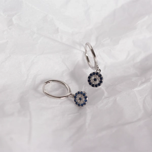 Detailed close-up of S925 sterling silver evil eye earrings with blue and white crystals