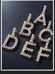 Detail of gold-plated copper letter pendants A to F with sparkling zircon inlay