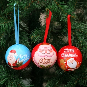 Festive Christmas ball ornaments with Santa patterns hanging on a green Xmas tree