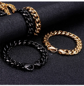 Detailed view of polished gold and black stainless steel Cuban link bracelets with lobster clasps