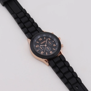 Geneva women's quartz watch with black silicone strap and rose gold case on white background