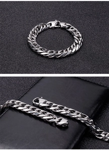 Close-up of a silver stainless steel curb chain bracelet with a sturdy lobster clasp
