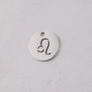 Macro shot of silver mirror-polished 12mm stainless steel Leo zodiac pendant charm