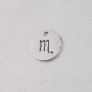 Macro shot of silver stainless steel 12mm round pendant with Scorpio zodiac cutout design