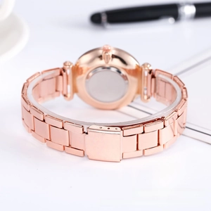 Detail view of the rose gold mesh watch band with a secure folding clasp mechanism