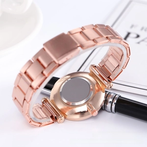 Detail of rose gold steel strap and polished stainless steel back case of woman quartz watch