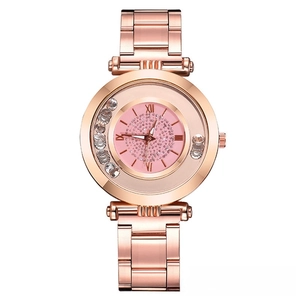 Détail du cadran de montre or rose avec centre à paillettes roses et chiffres romains