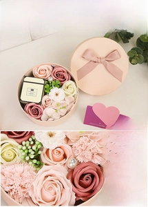 Pink soap rose gift set with aroma candle in a round box with a decorative bow