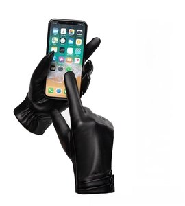 Detail of black touchscreen leather gloves showing wrist button and smartphone usage