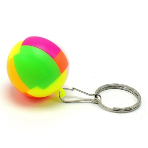 Close-up of a colorful mini 3D puzzle ball keychain with silver metal ring and D-hook