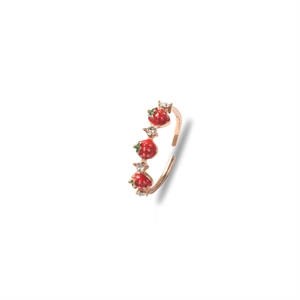 Rose gold adjustable ring featuring three enamel strawberries and sparkling rhinestones