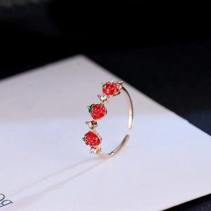Cute golden ring featuring red enamel strawberries and sparkling crystal rhinestones