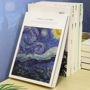 Thick 16K sketchbook featuring Van Gogh Starry Night cover on a wooden desk