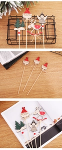 Detailed view of wooden Santa Claus and elk picks on table for Christmas decoration