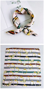 Detail view of a square silk scarf with classic stripes and golden ring buckle pattern