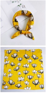 Detailed pattern of yellow floral silk square scarf with elegant knotted styling
