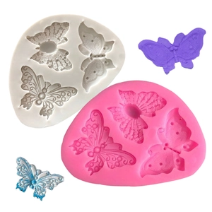 Detail of 3D butterfly silicone molds for fondant with finished purple and blue models