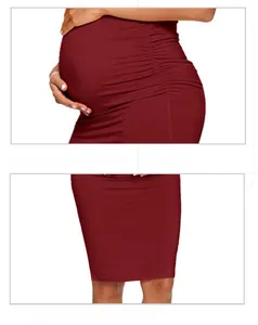 Detail of wine red maternity pencil dress with side ruching and slimming bodycon fit