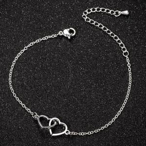 Minimalist silver stainless steel bracelet featuring interlocking double heart charms