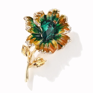 Exquisite floral brooch with green enamel petals and a central emerald water-drop gem