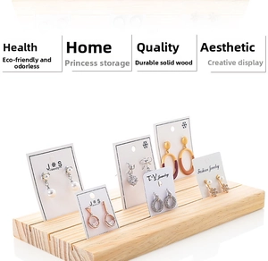 Detail view of wooden earring display stand with slots for creative jewelry presentation