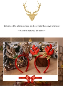 Close-up of festive Christmas reindeer antlers with glitter, sequins and bells on a red band